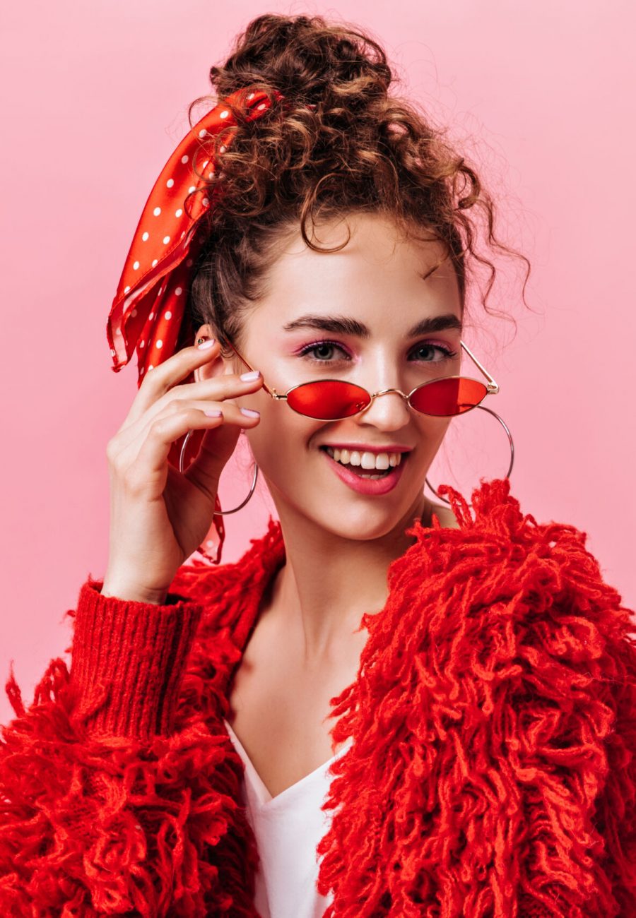 Portrait of pretty lady in red warm jacket and stylish eyeglasses